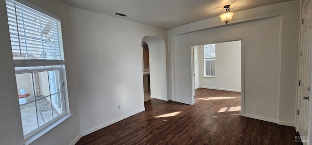 unfurnished room featuring dark hardwood / wood-style flooring