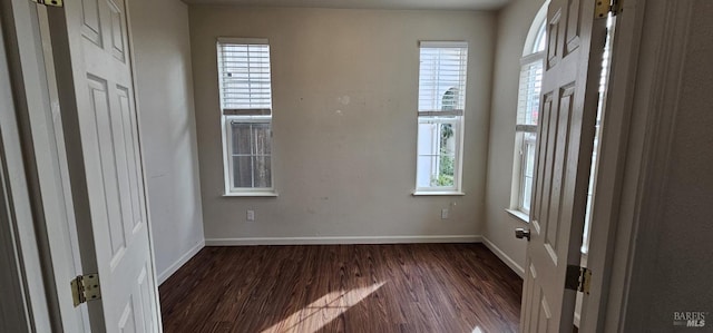 spare room featuring dark wood-type flooring