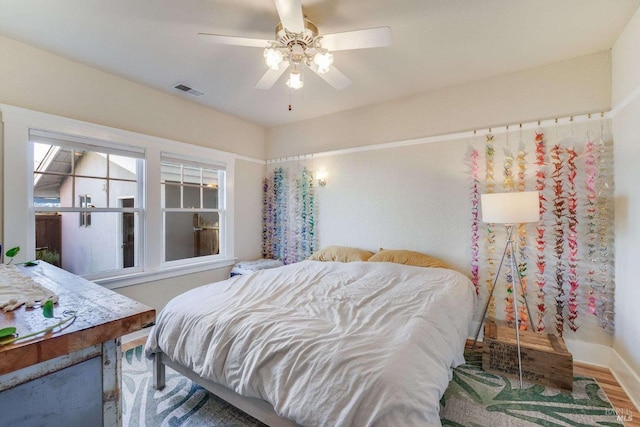 bedroom featuring hardwood / wood-style floors and ceiling fan