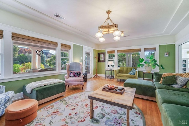 living room featuring hardwood / wood-style floors, a healthy amount of sunlight, and french doors