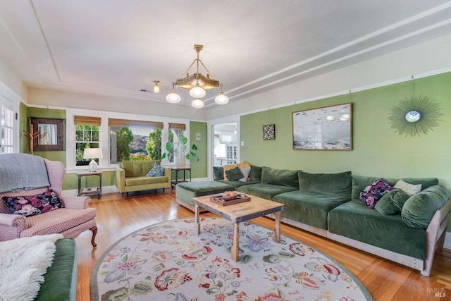 living room featuring a chandelier and wood-type flooring