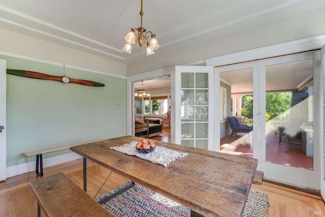 dining space with a chandelier and french doors