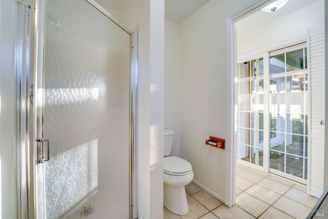 bathroom with toilet, a stall shower, and tile patterned floors