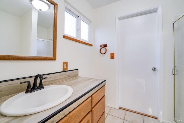 bathroom featuring tile patterned flooring, a shower stall, and vanity