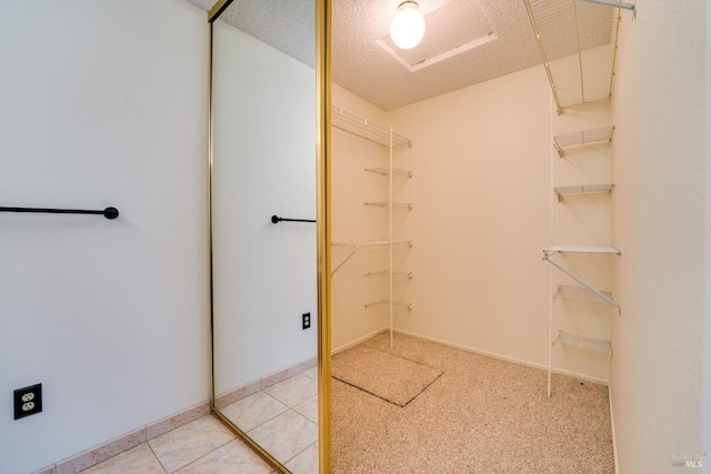 spacious closet with light tile patterned flooring