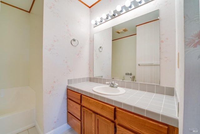 full bath featuring a bathing tub, visible vents, baseboards, vanity, and wallpapered walls