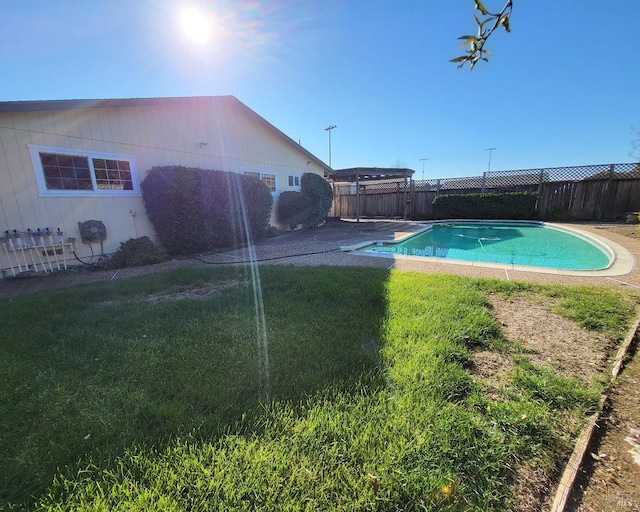 view of pool with a lawn