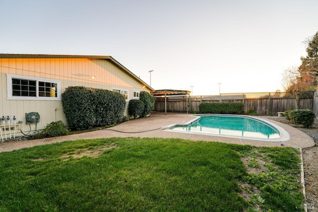 view of swimming pool with a fenced in pool, a fenced backyard, a yard, and a patio