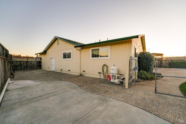 rear view of property with a patio, crawl space, and a fenced backyard