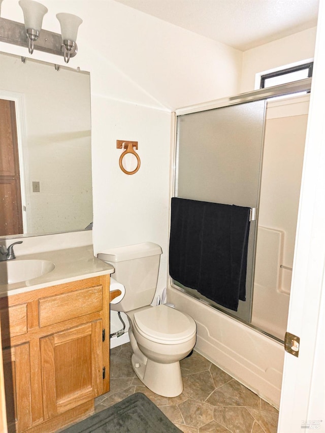 full bathroom featuring shower / bath combination with glass door, tile patterned floors, vanity, and toilet