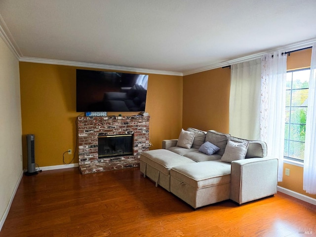 living room with ornamental molding, a fireplace, a healthy amount of sunlight, and hardwood / wood-style flooring