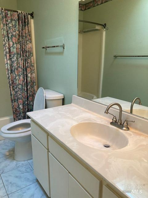 bathroom featuring toilet and vanity