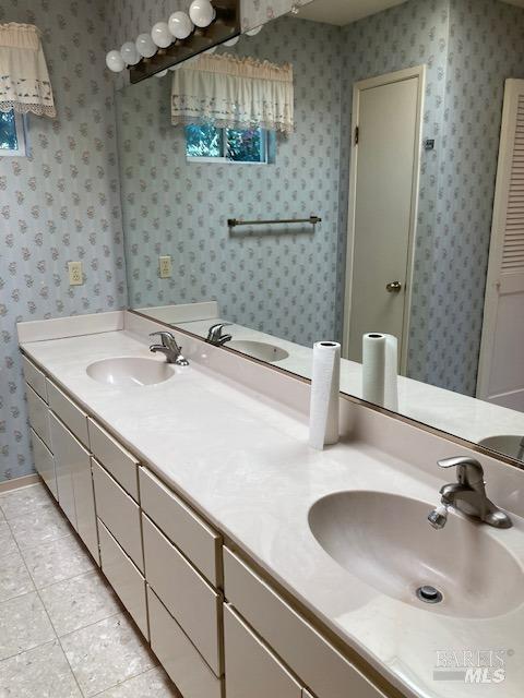 bathroom with vanity and tile patterned flooring