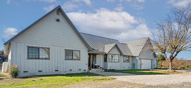 modern farmhouse style home with a garage and a front lawn