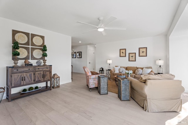 living room featuring ceiling fan and light hardwood / wood-style floors