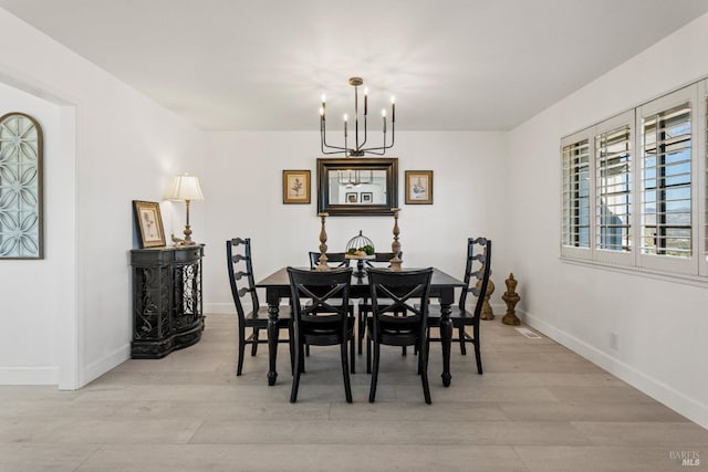 dining room with a chandelier and light wood-type flooring