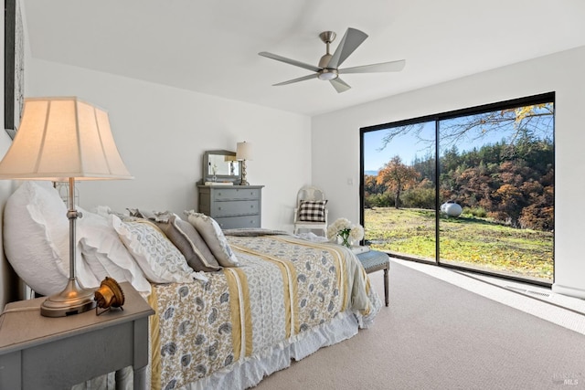 carpeted bedroom featuring ceiling fan and access to outside