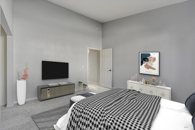 carpeted bedroom featuring a towering ceiling