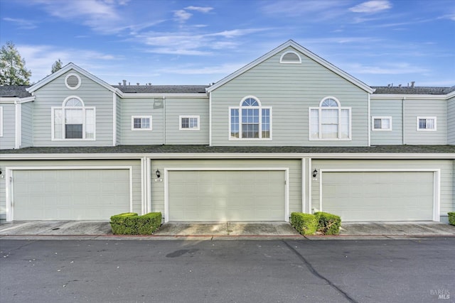 multi unit property featuring a garage