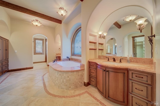 bathroom with beamed ceiling, a relaxing tiled tub, vanity, and tile patterned flooring