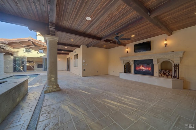 view of patio featuring exterior fireplace and ceiling fan