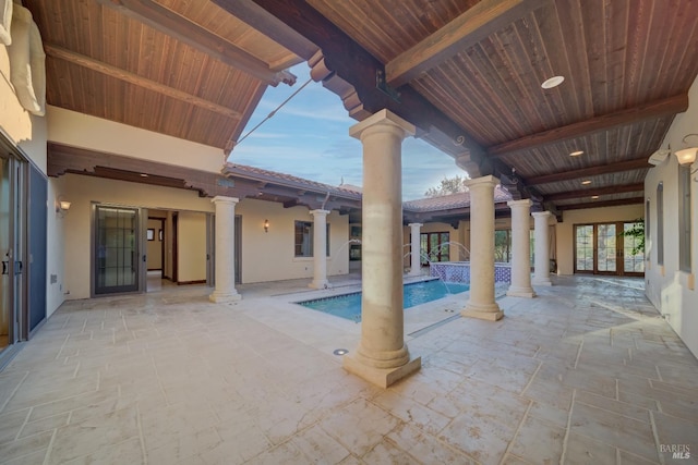 view of pool with pool water feature and a patio