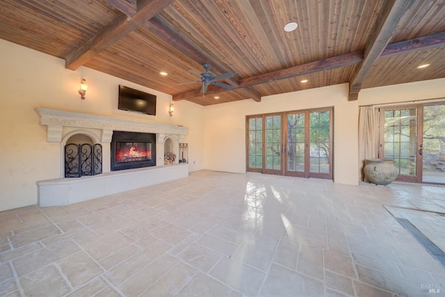 unfurnished living room with a wealth of natural light, french doors, and wooden ceiling