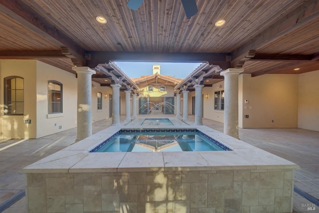 view of pool featuring an in ground hot tub and a patio