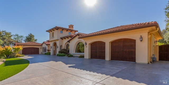 mediterranean / spanish-style house featuring a garage