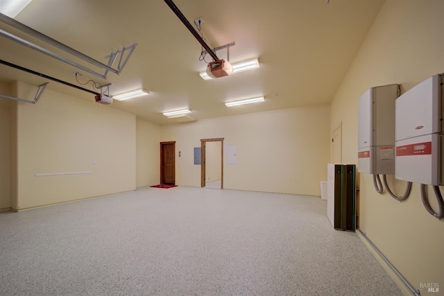 garage with electric panel and a garage door opener