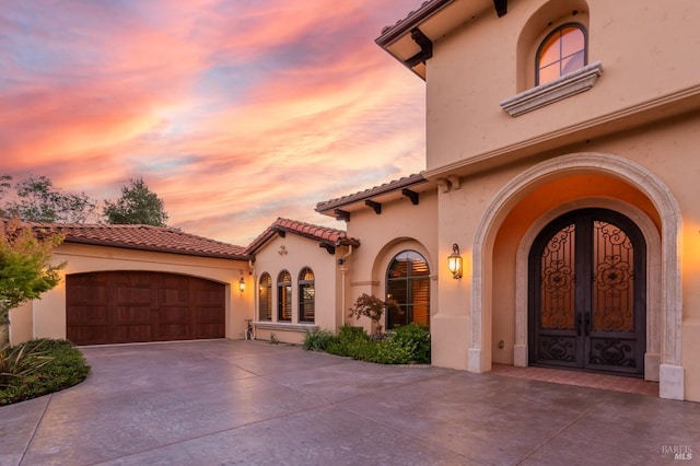 view of front facade with a garage and french doors