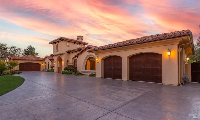 mediterranean / spanish house with a garage