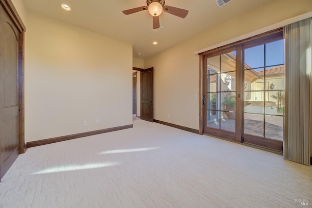 empty room with ceiling fan, light colored carpet, and french doors