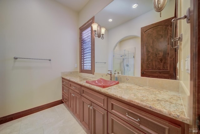 bathroom featuring tile patterned floors, vanity, and a shower with shower door