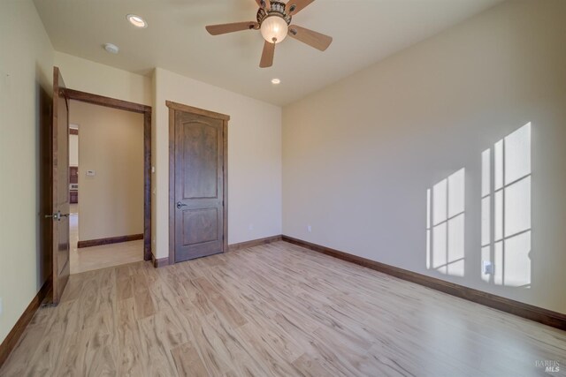 unfurnished bedroom with ceiling fan and light wood-type flooring