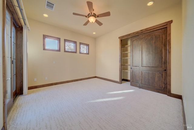 unfurnished bedroom with light carpet and ceiling fan