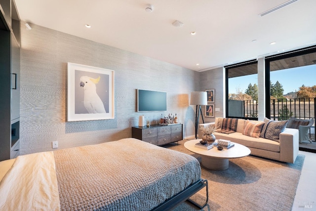 bedroom featuring access to exterior and floor to ceiling windows