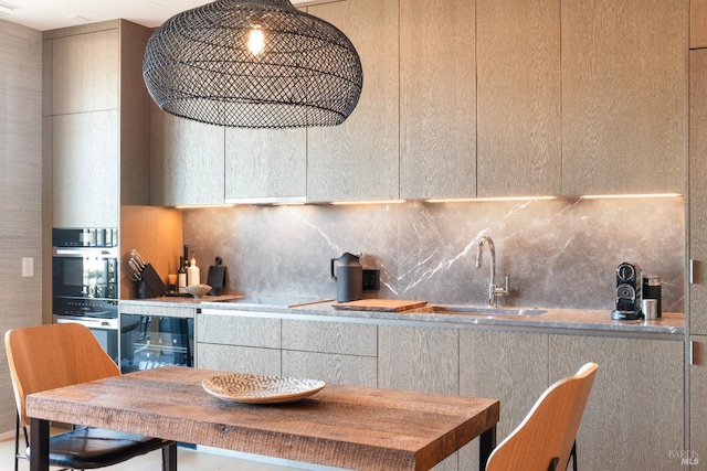 kitchen with tasteful backsplash, sink, oven, and beverage cooler