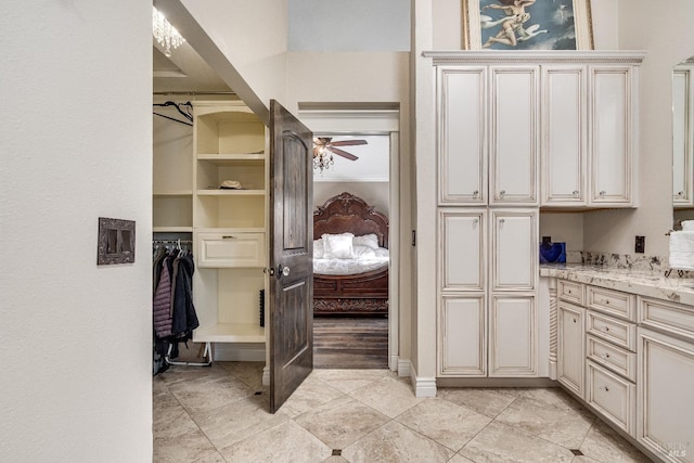 interior space featuring ceiling fan and crown molding