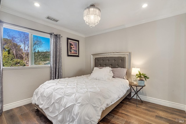 bedroom featuring ornamental molding, dark wood-type flooring, and an inviting chandelier