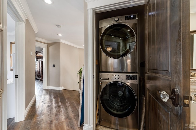 washroom featuring dark hardwood / wood-style flooring, stacked washer / dryer, and ornamental molding