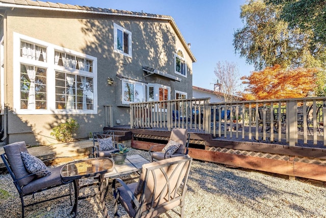 back of house with a wooden deck