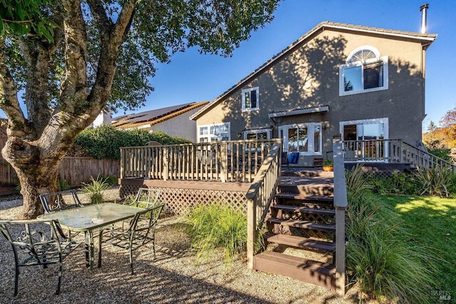 back of house featuring a wooden deck