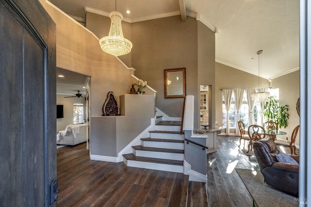 staircase featuring wood-type flooring, ceiling fan with notable chandelier, high vaulted ceiling, and ornamental molding