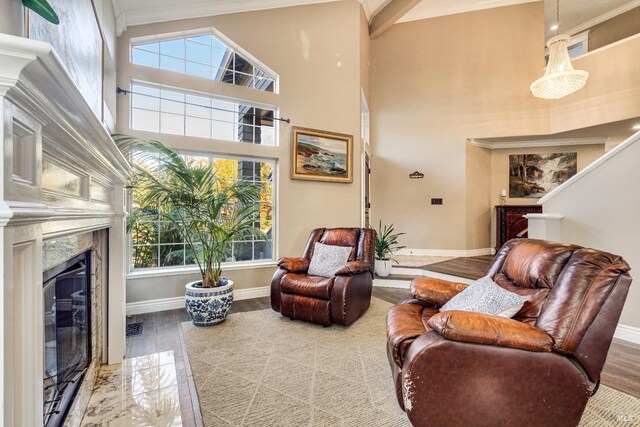 sitting room featuring hardwood / wood-style floors, a high end fireplace, and ornamental molding