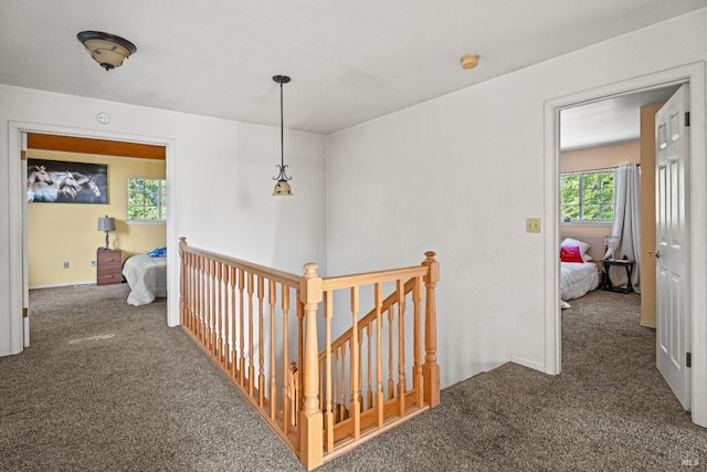 hallway featuring dark colored carpet