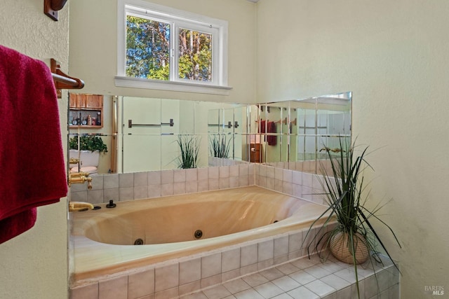 bathroom featuring tile patterned flooring and tiled tub