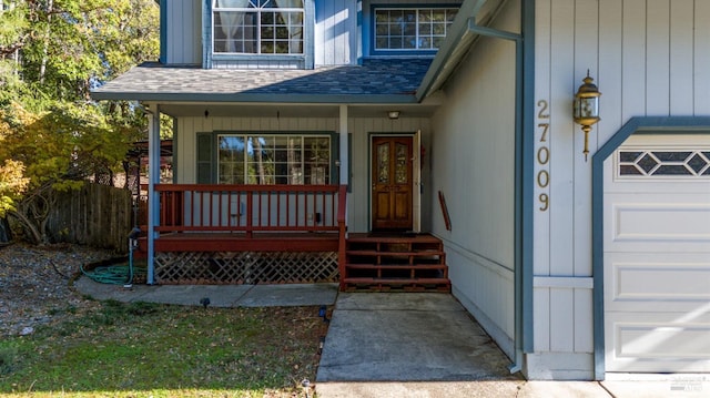 property entrance with a porch and a garage