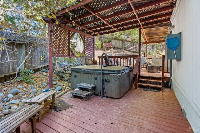 wooden deck featuring a hot tub