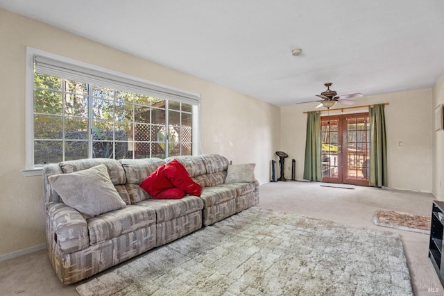 living room featuring light carpet, a wealth of natural light, and ceiling fan